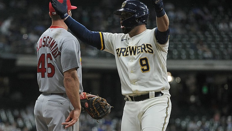 May 12, 2021; Milwaukee, Wisconsin, USA;  Milwaukee Brewers catcher Manny Pina (9) reacts to the Milwaukee Brewers bench after getting a hit against the St. Louis Cardinals in the fifth inning at American Family Field. Mandatory Credit: Michael McLoone-USA TODAY Sports