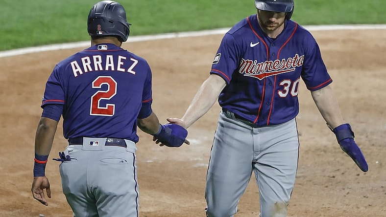 May 12, 2021; Chicago, Illinois, USA; Minnesota Twins left fielder Kyle Garlick (30) celebrates with second baseman Luis Arr  ez (2) after scoring against the Chicago White Sox during the third inning at Guaranteed Rate Field. Mandatory Credit: Kamil Krzaczynski-USA TODAY Sports