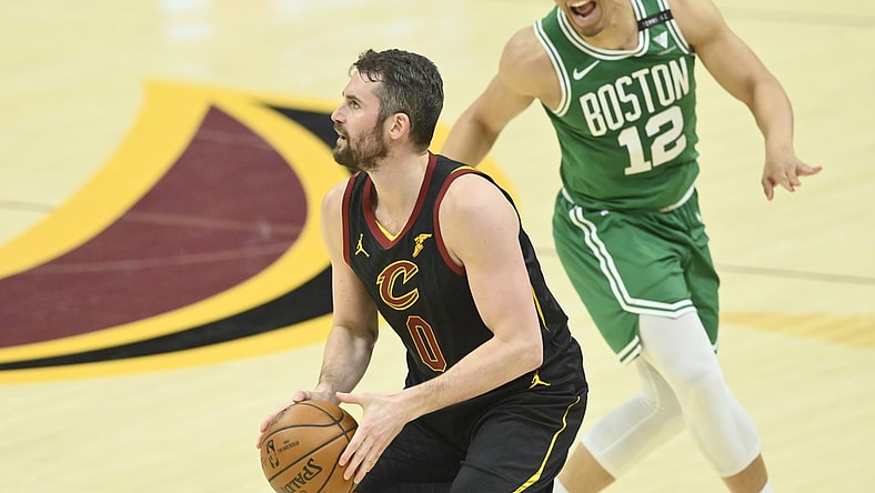 May 12, 2021; Cleveland, Ohio, USA; Cleveland Cavaliers forward Kevin Love (0) looks to shoot a three-point basket beside Boston Celtics forward Grant Williams (12) the third quarter at Rocket Mortgage FieldHouse. Mandatory Credit: David Richard-USA TODAY Sports