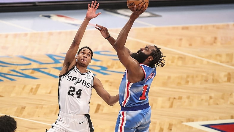 May 12, 2021; Brooklyn, New York, USA; Brooklyn Nets guard James Harden (R) shoots the ball over San Antonio Spurs guard Devin Vassell (24) during the fourth quarter at Barclays Center. Mandatory Credit: Wendell Cruz-USA TODAY Sports