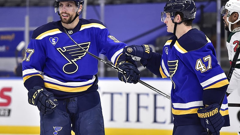 May 12, 2021; St. Louis, Missouri, USA;  St. Louis Blues left wing David Perron (57) is congratulated by defenseman Torey Krug (47) after scoring during the second period against the Minnesota Wild at Enterprise Center. Mandatory Credit: Jeff Curry-USA TODAY Sports