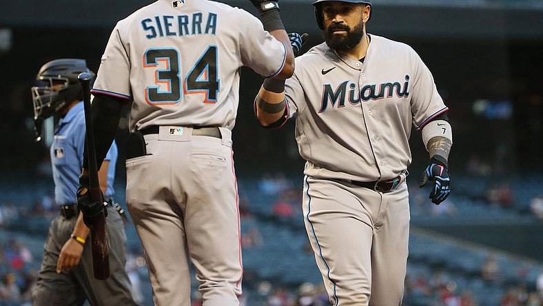Miami Marlins catcher Sandy Leon (right) is congratulated by Magneuris Sierra (34) after hitting a solo home run against the Arizona Diamondbacks during the second inning at Chase Field May 12, 2021.

Marlins Vs Diamondbacks