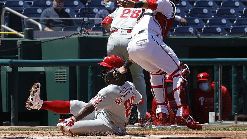 May 13, 2021; Washington, District of Columbia, USA; Philadelphia Phillies center fielder Andrew McCutchen (22) scores a run ahead of the tag of Washington Nationals catcher Yan Gomes (10) in the first inning at Nationals Park. Mandatory Credit: Geoff Burke-USA TODAY Sports