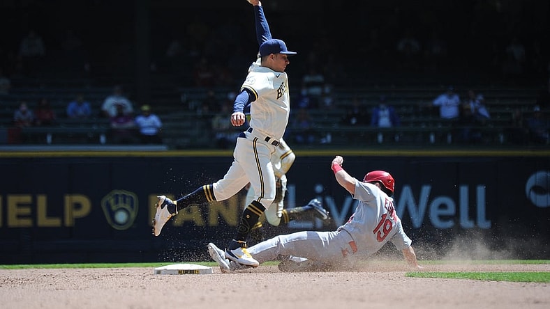 May 13, 2021; Milwaukee, Wisconsin, USA;  Milwaukee Brewers third baseman Luis Urias (2) is pulled off the bag as St. Louis Cardinals third baseman Tommy Edman (19) steals second base in the fifth inning at American Family Field. Mandatory Credit: Michael McLoone-USA TODAY Sports