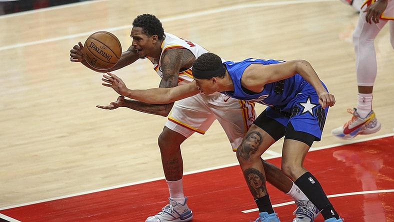 May 13, 2021; Atlanta, Georgia, USA; Atlanta Hawks guard Lou Williams (6) and Orlando Magic guard R.J. Hampton (13) reach for a loose ball in the first quarter at State Farm Arena. Mandatory Credit: Brett Davis-USA TODAY Sports