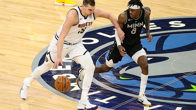 May 13, 2021; Minneapolis, Minnesota, USA; Denver Nuggets center Nikola Jokic (15) dribbles the ball while Minnesota Timberwolves forward Jarred Vanderbilt (8) defends in the first quarter at Target Center. Mandatory Credit: David Berding-USA TODAY Sports