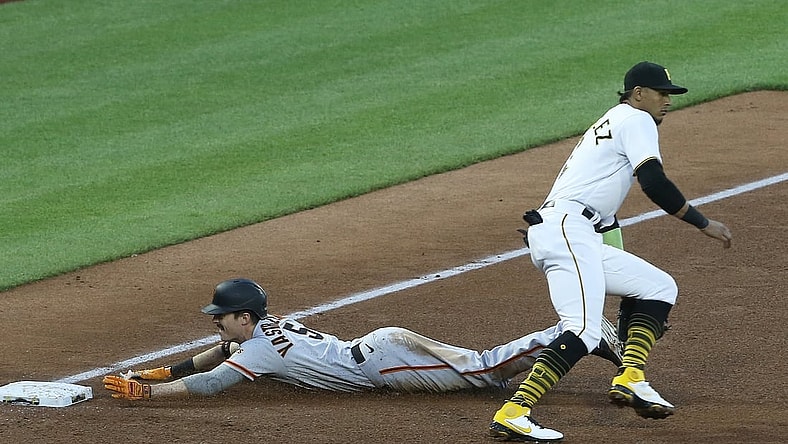 May 13, 2021; Pittsburgh, Pennsylvania, USA;  San Francisco Giants right fielder Mike Yastrzemski (5) slides into third base with an RBI triple as Pittsburgh Pirates third baseman Erik Gonzalez (2) awaits the throw during the fifth inning at PNC Park. Mandatory Credit: Charles LeClaire-USA TODAY Sports
