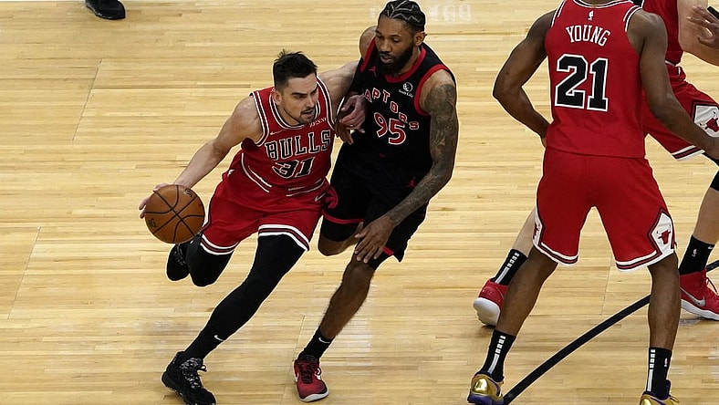 May 13, 2021; Chicago, Illinois, USA; Chicago Bulls guard Tomas Satoransky (31) is defended by Toronto Raptors guard DeAndre' Bembry (95) during the first half at United Center. Mandatory Credit: David Banks-USA TODAY Sports
