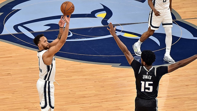 May 13, 2021; Memphis, Tennessee, USA; Memphis Grizzlies forward Kyle Anderson (1) shoots against Sacramento Kings center Damian Jones (15) during the first half  at FedExForum. Mandatory Credit: Justin Ford-USA TODAY Sports