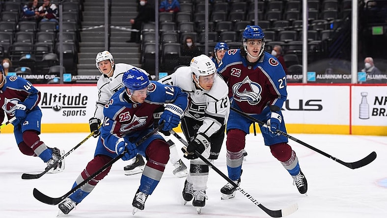 May 13, 2021; Denver, Colorado, USA; Colorado Avalanche center Jayson Megna (12) and Los Angeles Kings center Trevor Moore (12) and defenseman Ryan Graves (27) during the first period at Ball Arena. Mandatory Credit: Ron Chenoy-USA TODAY Sports