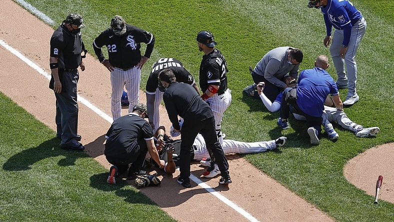 May 14, 2021; Chicago, Illinois, USA; Chicago White Sox first baseman Jose Abreu (79) and Kansas City Royals third baseman Hunter Dozier (17) lay on the field after colliding along the first base line during the second inning of the first game of a doubleheader at Guaranteed Rate Field. Mandatory Credit: Kamil Krzaczynski-USA TODAY Sports