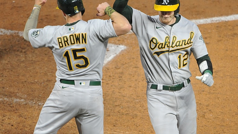 May 14, 2021; Minneapolis, Minnesota, USA; Oakland Athletics Sean Murphy catcher (12) celebrates his home run with Seth Brown left fielder (15) during the fourth inning against the Minnesota Twins at Target Field. Mandatory Credit: Marilyn Indahl-USA TODAY Sports