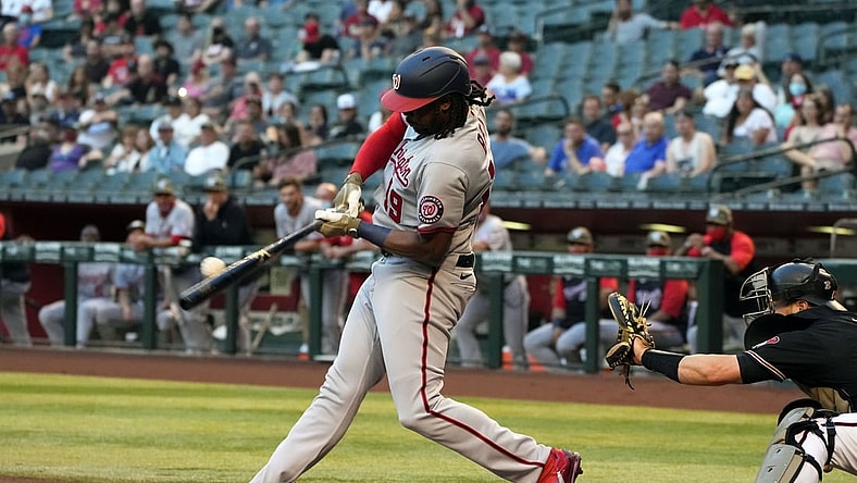 May 14, 2021; Phoenix, Arizona, USA; Washington Nationals first baseman Josh Bell (19) hits a two run RBI double against the Arizona Diamondbacks in the first inning at Chase Field. Mandatory Credit: Rick Scuteri-USA TODAY Sports