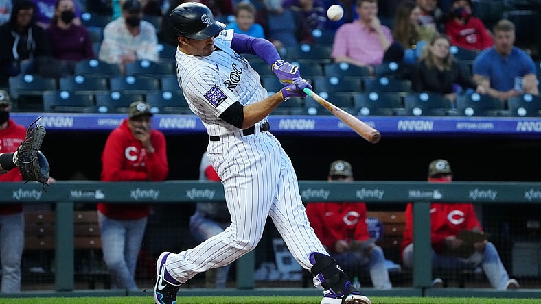 May 14, 2021; Denver, Colorado, USA; Colorado Rockies third baseman Josh Fuentes (8) hits an RBI single in the third inning against the Cincinnati Reds at Coors Field. Mandatory Credit: Ron Chenoy-USA TODAY Sports