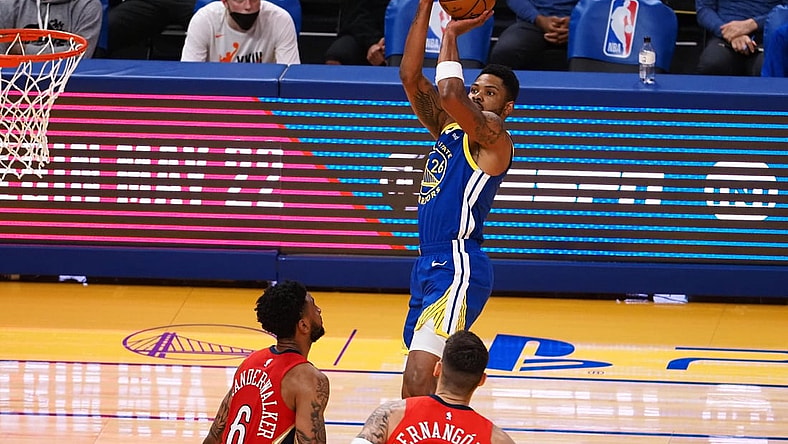 May 14, 2021; San Francisco, California, USA; Golden State Warriors guard-forward Kent Bazemore (26) scores a basket above New Orleans Pelicans guard Nickeil Alexander-Walker (6) and center-forward Willy Hernangomez (9) during the second quarter at Chase Center. Mandatory Credit: Kelley L Cox-USA TODAY Sports