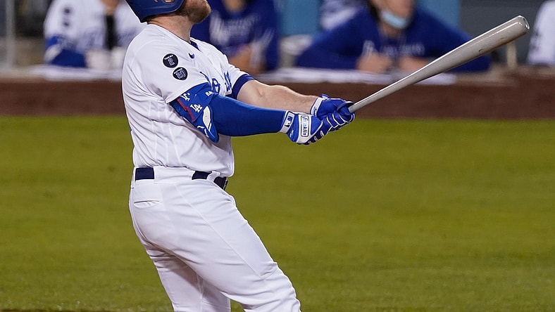 May 14, 2021; Los Angeles, California, USA; Los Angeles Dodgers first baseman Max Muncy (13) watches his three-run homer clear the fence in the second inning against the Miami Marlins at Dodger Stadium. Mandatory Credit: Robert Hanashiro-USA TODAY Sports