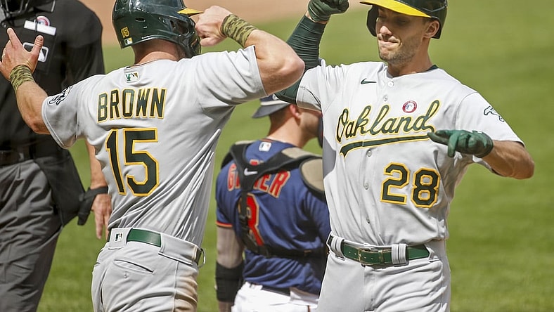May 15, 2021; Minneapolis, Minnesota, USA; Oakland Athletics first baseman Matt Olson (28) celebrates with Oakland Athletics designated hitter Seth Brown (15) after his home run that brought Brown home against the Minnesota Twins in the first inning at Target Field. Mandatory Credit: Bruce Kluckhohn-USA TODAY Sports