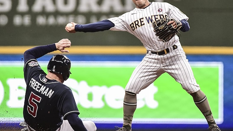 May 15, 2021; Milwaukee, Wisconsin, USA; Atlanta Braves first baseman Freddie Freeman (5) breaks up a double play attempt by Milwaukee Brewers second baseman Kolten Wong (16) in the fourth inning at American Family Field. Mandatory Credit: Benny Sieu-USA TODAY Sports