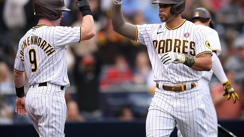 May 15, 2021; San Diego, California, USA; San Diego Padres left fielder Tommy Pham (R) is congratulated by  second baseman Jake Cronenworth (9) after hitting a two-run home run against the St. Louis Cardinals during the first inning at Petco Park. Mandatory Credit: Orlando Ramirez-USA TODAY Sports