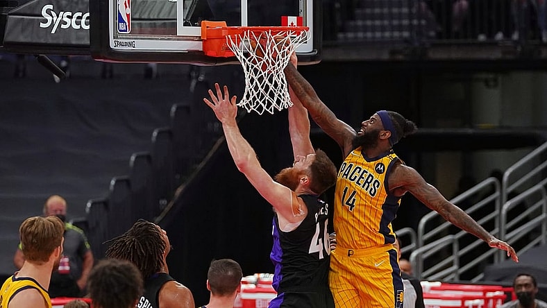 May 16, 2021; Tampa, Florida, USA; Indiana Pacers forward JaKarr Sampson (14) fouls Toronto Raptors center Aron Baynes (46) during the first half at Amalie Arena. Mandatory Credit: Jasen Vinlove-USA TODAY Sports