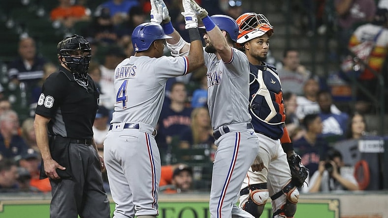 May 16, 2021; Houston, Texas, USA;  Texas Rangers designated hitter Khris Davis (4) celebrates left fielder David Dahl (21) two run home run against the Houston Astros in the seventh inning at Minute Maid Park. Mandatory Credit: Thomas Shea-USA TODAY Sports