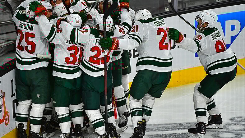 May 16, 2021; Las Vegas, Nevada, USA; Minnesota Wild players celebrate after Minnesota Wild center Joel Eriksson Ek (14) scored an overtime goal to defeat the Vegas Golden Knights 1-0 in game one of the first round of the 2021 Stanley Cup Playoffs at T-Mobile Arena. Mandatory Credit: Stephen R. Sylvanie-USA TODAY Sports