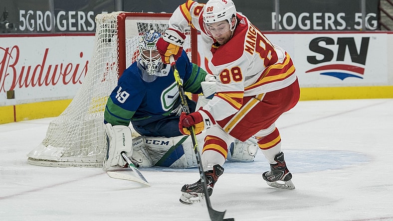 May 16, 2021; Vancouver, British Columbia, CAN; Vancouver Canucks goalie Braden Holtby (49) watches Calgary Flames forward Andrew Mangiapane (88) control he puck in the second period at Rogers Arena. Mandatory Credit: Bob Frid-USA TODAY Sports