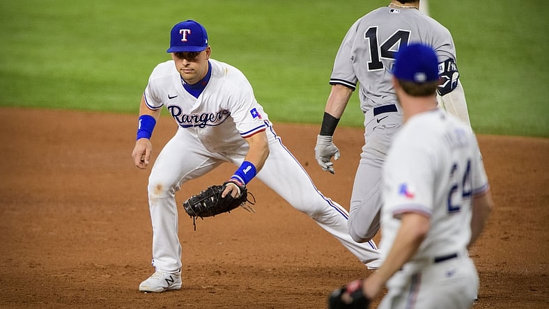 May 17, 2021; Arlington, Texas, USA; Texas Rangers first baseman Nate Lowe (30) puts out New York Yankees shortstop Tyler Wade (14) on a throw from starting pitcher Jordan Lyles (24) during the fifth inning at Globe Life Field. Mandatory Credit: Jerome Miron-USA TODAY Sports