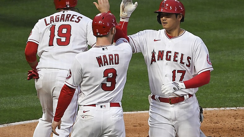 May 17, 2021; Anaheim, California, USA; Los Angeles Angels designated hitter Shohei Ohtani (17) is congratulated by right fielder Taylor Ward (3) and left fielder Juan Lagares (19) after hitting a two-run home run against the Cleveland Indians during the second inning at Angel Stadium. Mandatory Credit: Richard Mackson-USA TODAY Sports