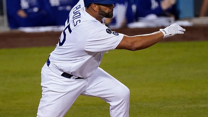 May 17, 2021; Los Angeles, California, USA;  Los Angeles Dodgers first baseman Albert Pujols (55) singles in the third inning to drive in a run against the Arizona Diamondbacks at Dodger Stadium. It was Pujols' first game as a Dodger after signing a contract earlier in the day. Mandatory Credit: Robert Hanashiro-USA TODAY Sports