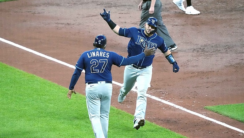 May 18, 2021; Baltimore, Maryland, USA; Tampa Bay Rays catcher Mike Zunino (10) is greeted by third base coach Rodney Linares (27) following his two run home run in the third inning against the Baltimore Orioles at Oriole Park at Camden Yards. Mandatory Credit: Mitch Stringer-USA TODAY Sports