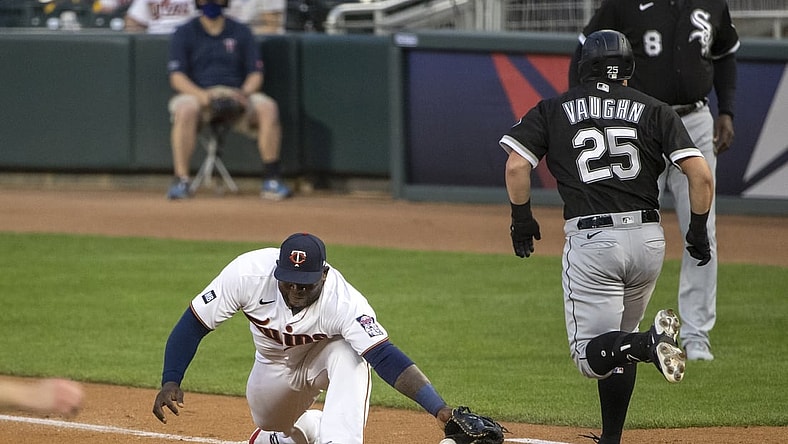 May 18, 2021; Minneapolis, Minnesota, USA; Chicago White Sox first baseman Andrew Vaughn (25) reaches first base before Minnesota Twins first baseman Miguel Sano (22) can catch the ball in the second inning at Target Field. Mandatory Credit: Jesse Johnson-USA TODAY Sports