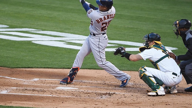 May 18, 2021; Oakland, California, USA; Houston Astros left fielder Michael Brantley (23) hits a single against the Oakland Athletics during the third inning at RingCentral Coliseum. Mandatory Credit: Kelley L Cox-USA TODAY Sports