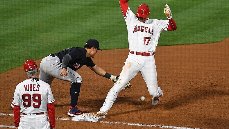 May 18, 2021; Anaheim, California, USA; Los Angeles Angels designated hitter Shohei Ohtani (17) is safe at first base against Cleveland Indians shortstop Yu Chang (2) in the fourth inning at Angel Stadium. Mandatory Credit: Richard Mackson-USA TODAY Sports