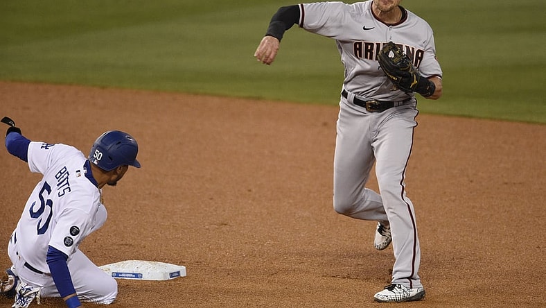 May 18, 2021; Los Angeles, California, USA; Arizona Diamondbacks shortstop Nick Ahmed (13) throws to first after forcing out Los Angeles Dodgers center fielder Mookie Betts (50) at second base during the third inning at Dodger Stadium. Mandatory Credit: Kelvin Kuo-USA TODAY Sports