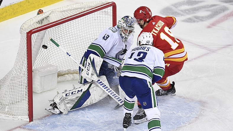 May 19, 2021; Calgary, Alberta, CAN; Calgary Flames forward Matthew Tkachuk (19) scores on Vancouver Canucks goalie Braden Holtby (49) during the first period at Scotiabank Saddledome. Mandatory Credit: Candice Ward-USA TODAY Sports