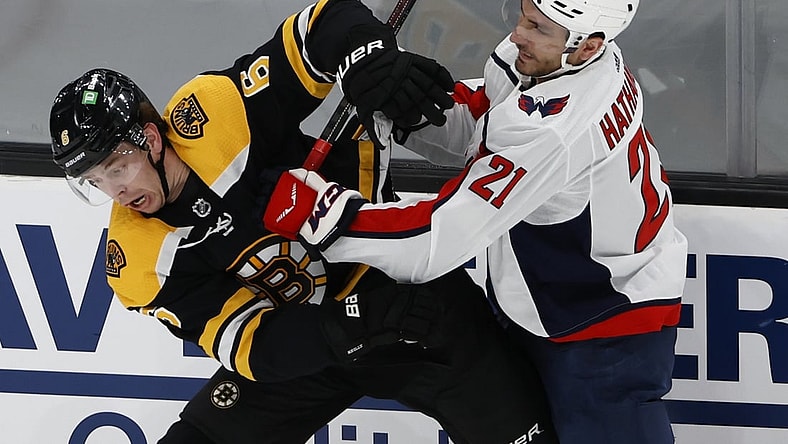 May 19, 2021; Boston, Massachusetts, USA; Washington Capitals right wing Garnet Hathaway (21) checks Boston Bruins defenseman Mike Reilly (6) during the first period in game three of the first round of the 2021 Stanley Cup Playoffs at TD Garden. Mandatory Credit: Winslow Townson-USA TODAY Sports