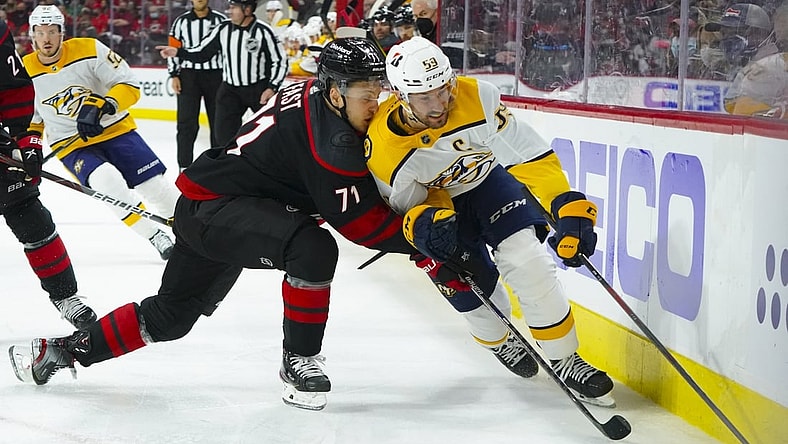 May 19, 2021; Raleigh, North Carolina, USA; Nashville Predators defenseman Roman Josi (59) skates with the puck against Carolina Hurricanes right wing Jesper Fast (71) during the first period in game two of the first round of the 2021 Stanley Cup Playoffs at PNC Arena. Mandatory Credit: James Guillory-USA TODAY Sports