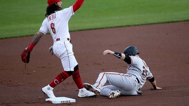 Cincinnati Reds second baseman Jonathan India (6) follows through on an errant throw to first as San Francisco Giants catcher Buster Posey (28) slides into second base on an attempted double play in the first inning during a baseball game against the San Francisco Giants, Wednesday, May 19, 2021, at Great American Ball Park in Cincinnati.

San Francisco Giants At Cincinnati Reds May 19