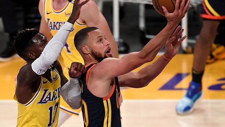 May 19, 2021; Los Angeles, California, USA;   Golden State Warriors guard Stephen Curry (30) gets past Los Angeles Lakers guard Dennis Schroder (17) and Los Angeles Lakers guard Alex Caruso (4) as he drives to the basket in the first half of the game at Staples Center. Mandatory Credit: Jayne Kamin-Oncea-USA TODAY Sports