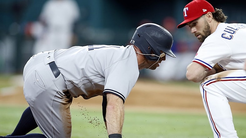 May 20, 2021; Arlington, Texas, USA; New York Yankees center fielder Brett Gardner (11) is safe at third base on a wild pitch as Texas Rangers third baseman Charlie Culberson (2) defends in the fourth inning at Globe Life Field. Mandatory Credit: Tim Heitman-USA TODAY Sports