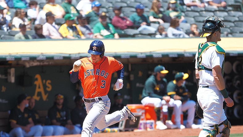May 20, 2021; Oakland, California, USA; Houston Astros center fielder Myles Straw (3) scores a run behind Oakland Athletics catcher Sean Murphy (12) during the third inning at RingCentral Coliseum. Mandatory Credit: Kelley L Cox-USA TODAY Sports