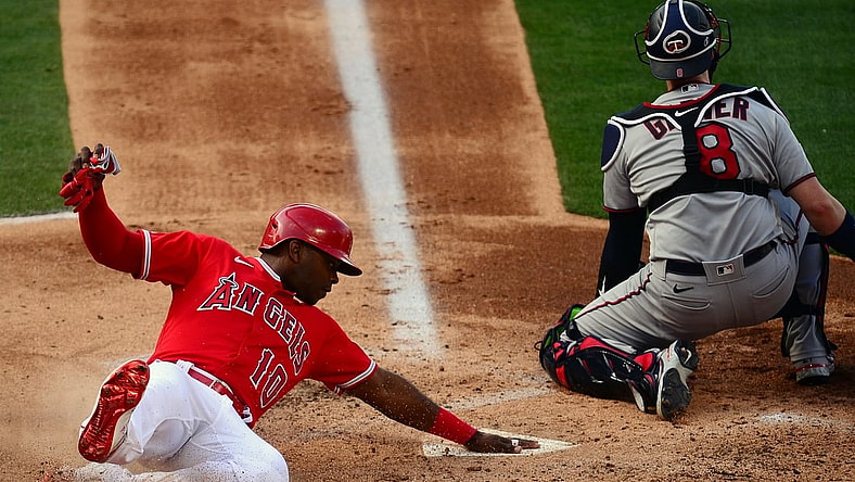 May 20, 2021; Anaheim, California, USA; Los Angeles Angels left fielder Justin Upton (10) scores a run ahead of Minnesota Twins catcher Mitch Garver (8) during the second inning at Angel Stadium. Mandatory Credit: Gary A. Vasquez-USA TODAY Sports