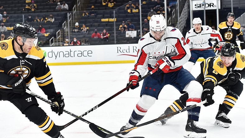 May 21, 2021; Boston, Massachusetts, USA; Boston Bruins left wing Taylor Hall (71) Washington Capitals right wing Garnet Hathaway (21) and defenseman Mike Reilly (6) battle for the puck during the first period in game four of the first round of the 2021 Stanley Cup Playoffs at TD Garden. Mandatory Credit: Bob DeChiara-USA TODAY Sports