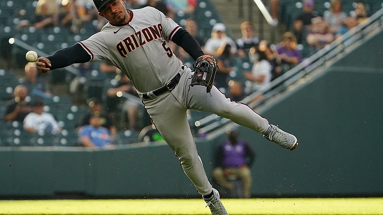 May 21, 2021; Denver, Colorado, USA; Arizona Diamondbacks third baseman Eduardo Escobar (5) fields the ball in the first inning against the Colorado Rockies at Coors Field. Mandatory Credit: Ron Chenoy-USA TODAY Sports