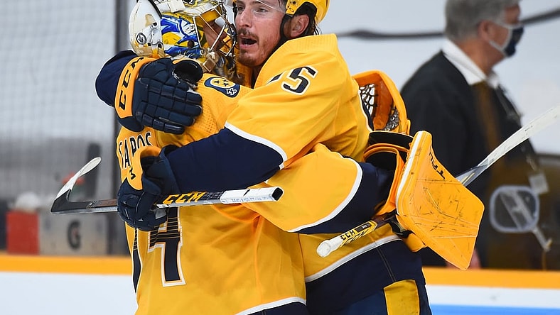 May 21, 2021; Nashville, Tennessee, USA; Nashville Predators center Matt Duchene (95) celebrates with goaltender Juuse Saros (74) after scoring the game-winning goal in the second overtime against the Carolina Hurricanes in game three of the first round of the 2021 Stanley Cup Playoffs at Bridgestone Arena. Mandatory Credit: Christopher Hanewinckel-USA TODAY Sports