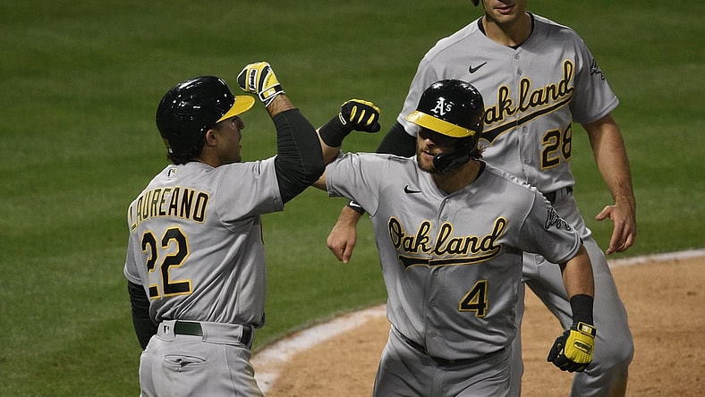 May 21, 2021; Anaheim, California, USA; Oakland Athletics second baseman Chad Pinder (4) celebrates with center fielder Ramon Laureano (22) after a three-run home run during the seventh inning against the Los Angeles Angels at Angel Stadium. Mandatory Credit: Kelvin Kuo-USA TODAY Sports