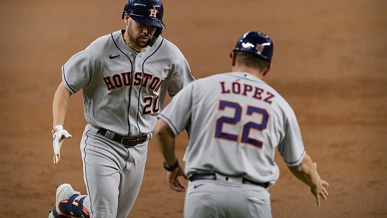 May 22, 2021; Arlington, Texas, USA; Houston Astros center fielder Chas McCormick (20) and first base coach Omar Lopez (22) celebrate McCormick hitting a home run against the Texas Rangers during the second inning at Globe Life Field. Mandatory Credit: Jerome Miron-USA TODAY Sports