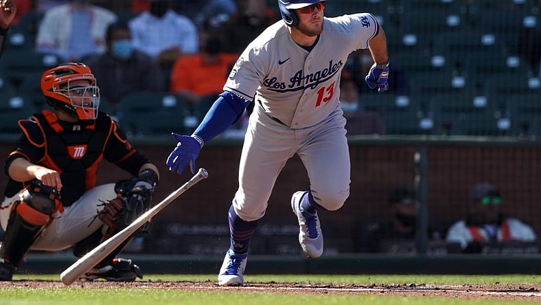 May 22, 2021; San Francisco, California, USA; Los Angeles Dodgers second baseman Max Muncy (13) hits a single during the fourth inning against the San Francisco Giants at Oracle Park. Mandatory Credit: Darren Yamashita-USA TODAY Sports