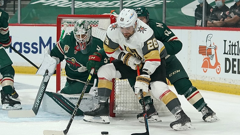 May 22, 2021; Saint Paul, Minnesota, USA; Vegas Golden Knights left wing William Carrier (28) protects the puck from Minnesota Wild center Nick Bonino (13) in front of Minnesota goaltender Cam Talbot (33) during the first period in game four of the first round of the 2021 Stanley Cup Playoffs at Xcel Energy Center. Mandatory Credit: Nick Wosika-USA TODAY Sports